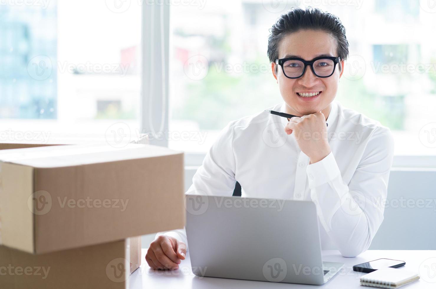 Asian businessman packing goods to send to customers photo