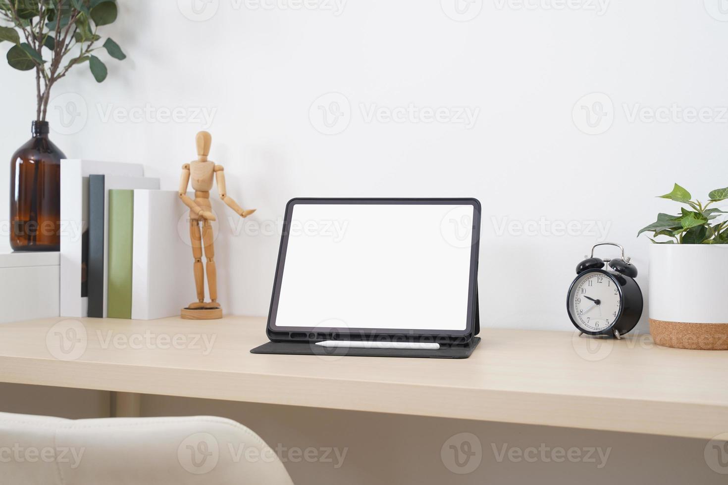 Blank screen tablet with digital pencil on the wooden table. photo