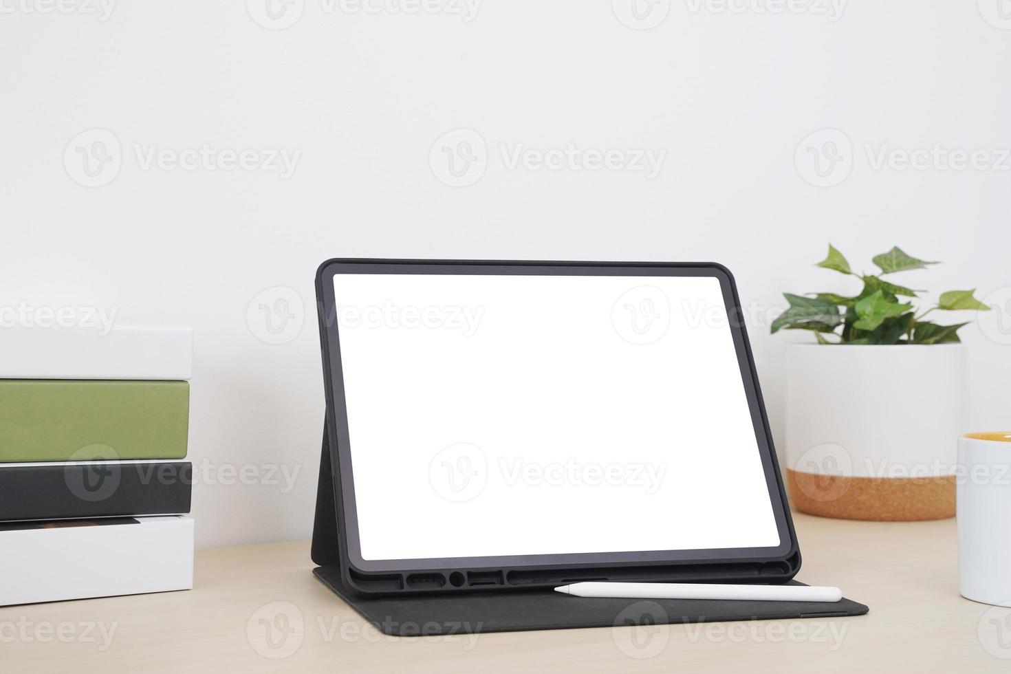 Blank screen tablet with digital pencil on the table. photo