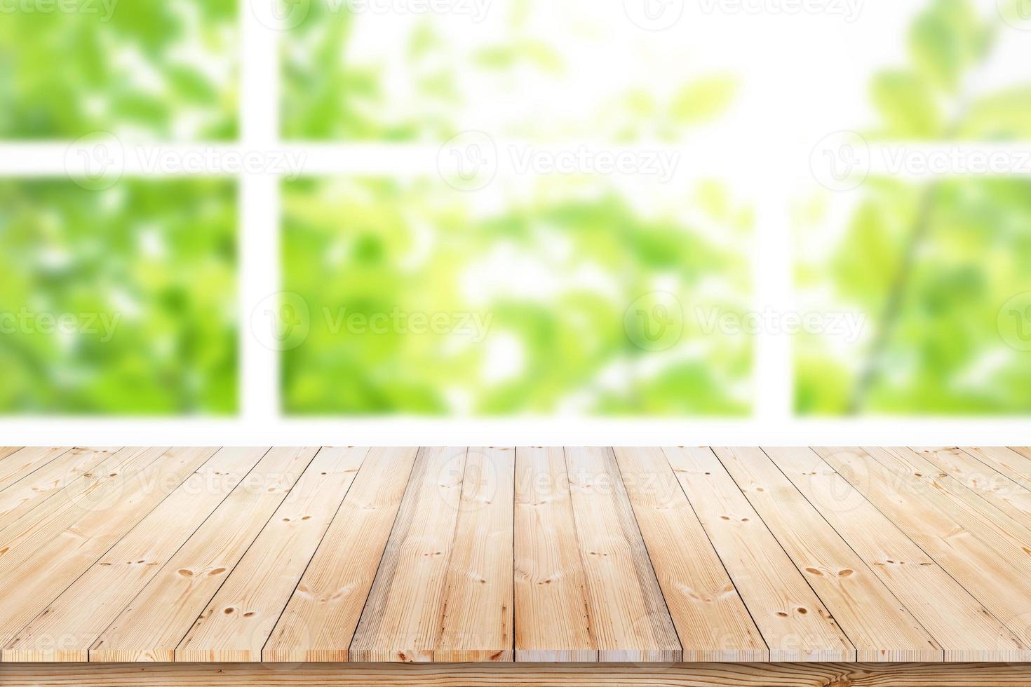 Empty wood table top on blur green leaf garden from window view in the morning. For product display or design key visual layout. photo