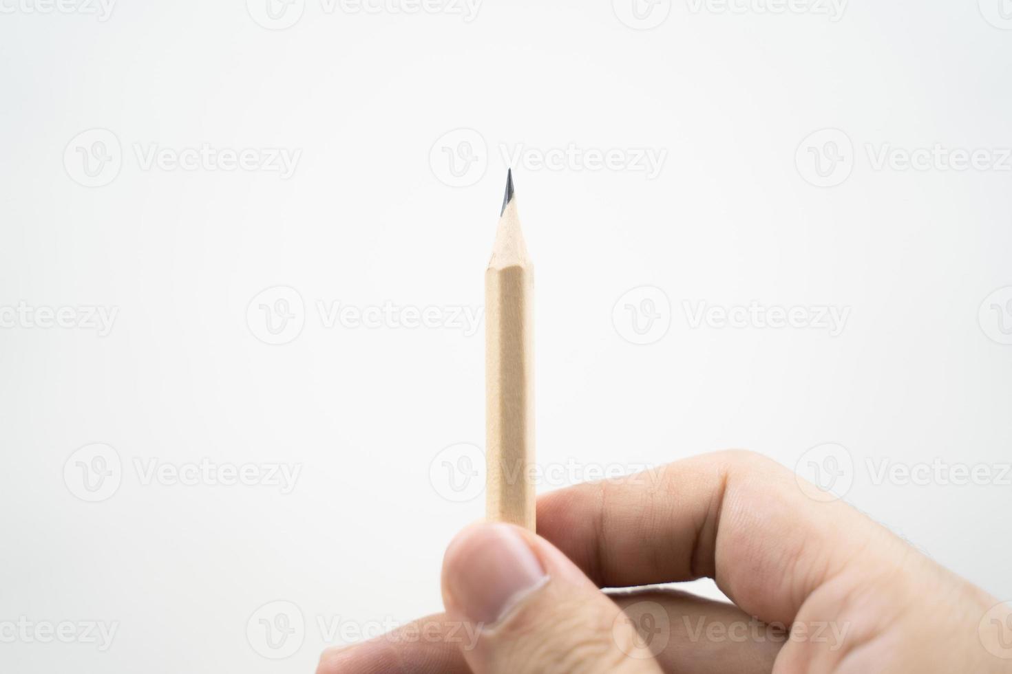 Hand holding a wooden pencil on white background. Designer concept. Selective focus. photo