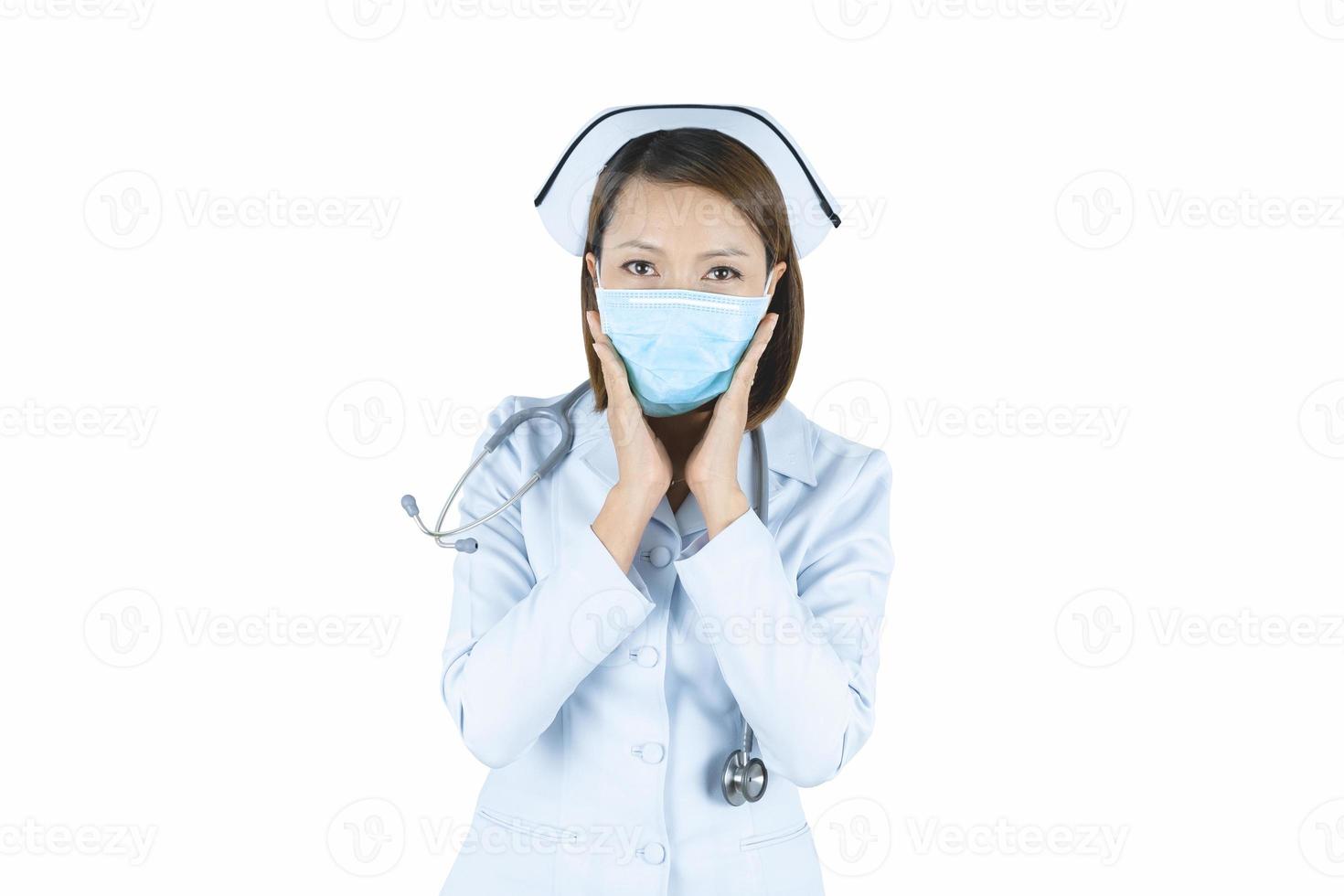Asian doctor woman or hospital nurse in scrubs using protective medical face mask in prevention vs virus infection. photo
