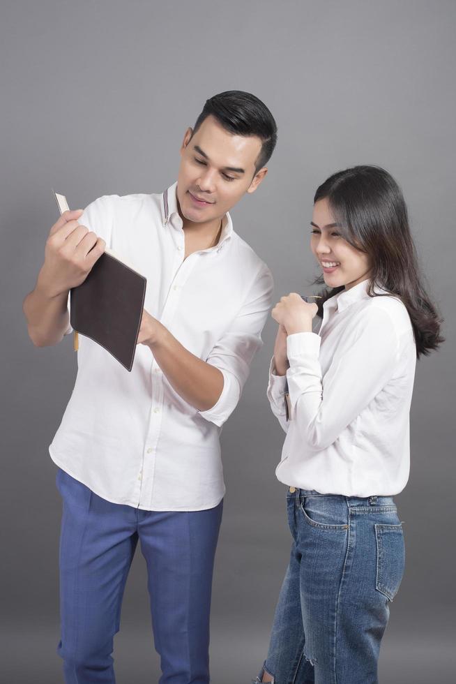 Two young people in white shirts and grey background photo