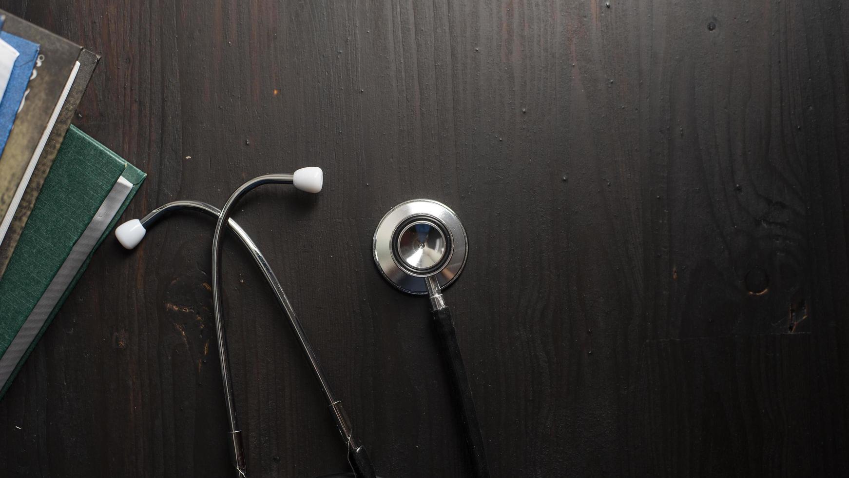 Stethoscope on desk with books photo