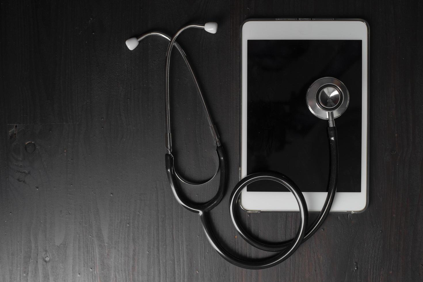 Close-up of medical stethoscope on tablet computer photo