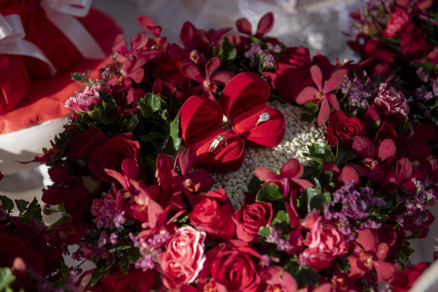 Pair of wedding rings on red rose photo