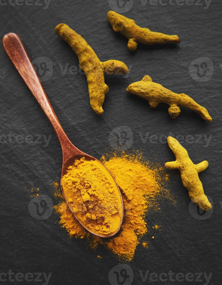 Turmeric powder and turmeric root photo