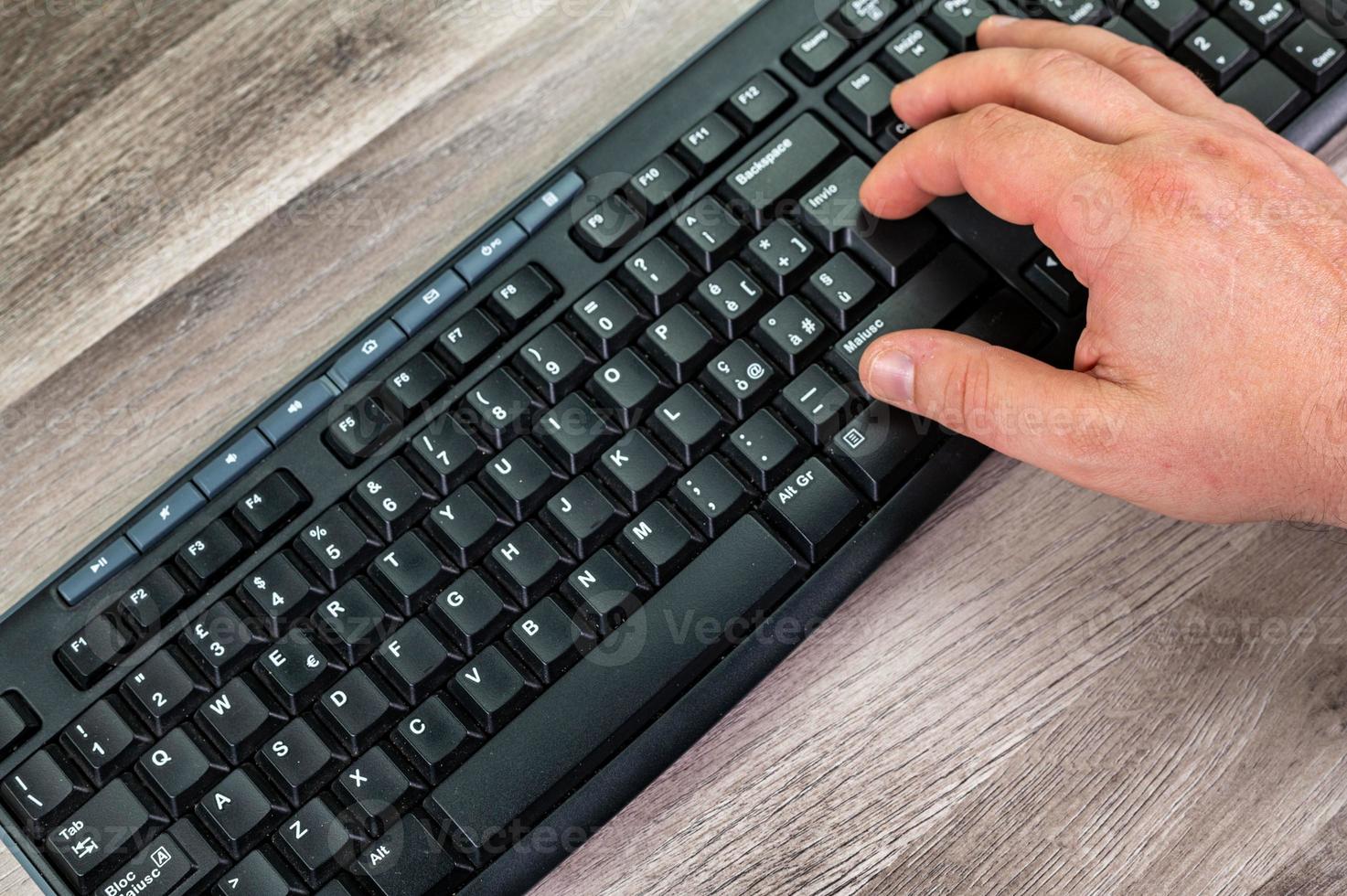 hands of a man typing on the pc keyboard photo
