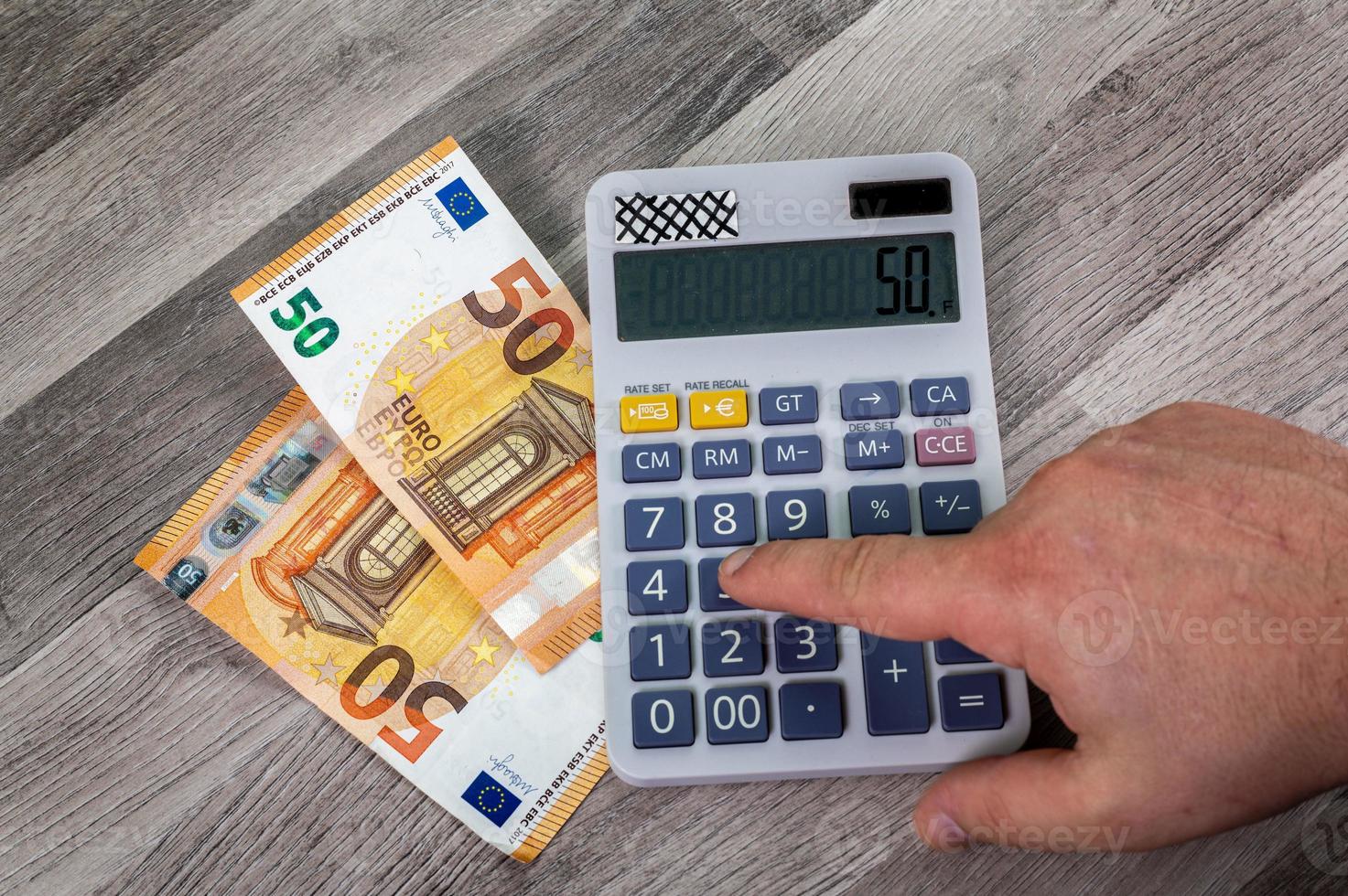 50 euro bills with calculator nearby photo