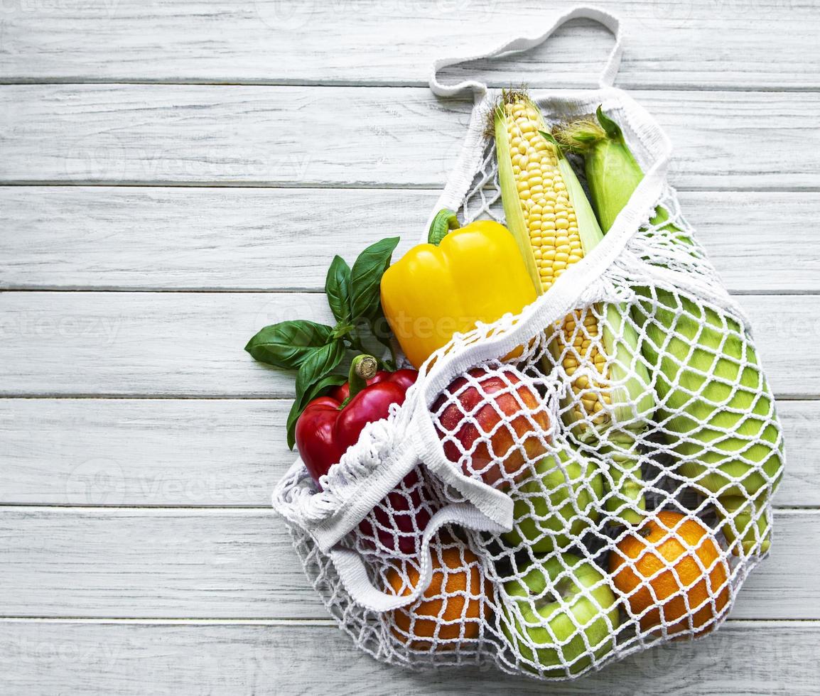 Fresh vegetables and fruits on eco string bag photo