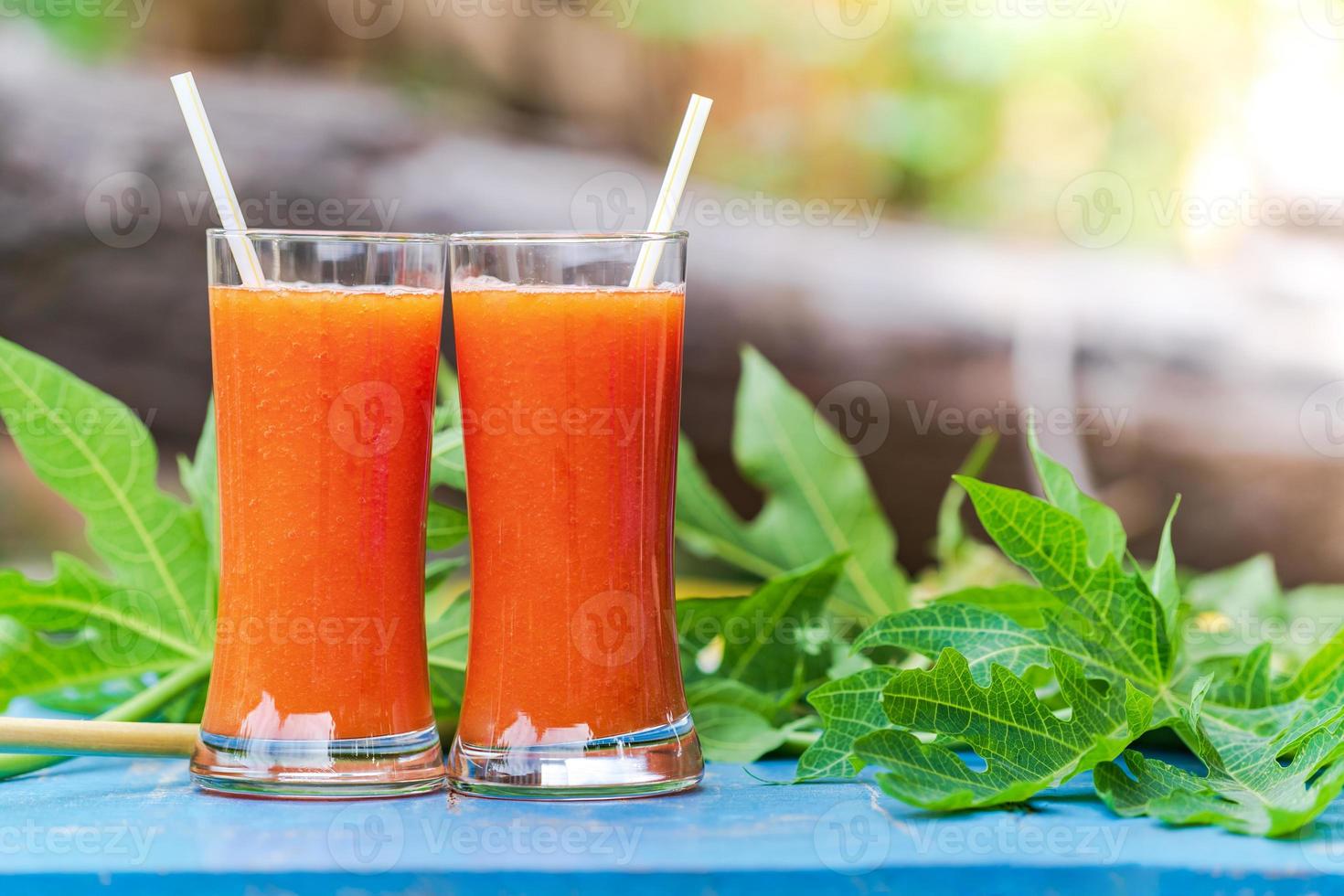 Papaya juice on a wooden table photo