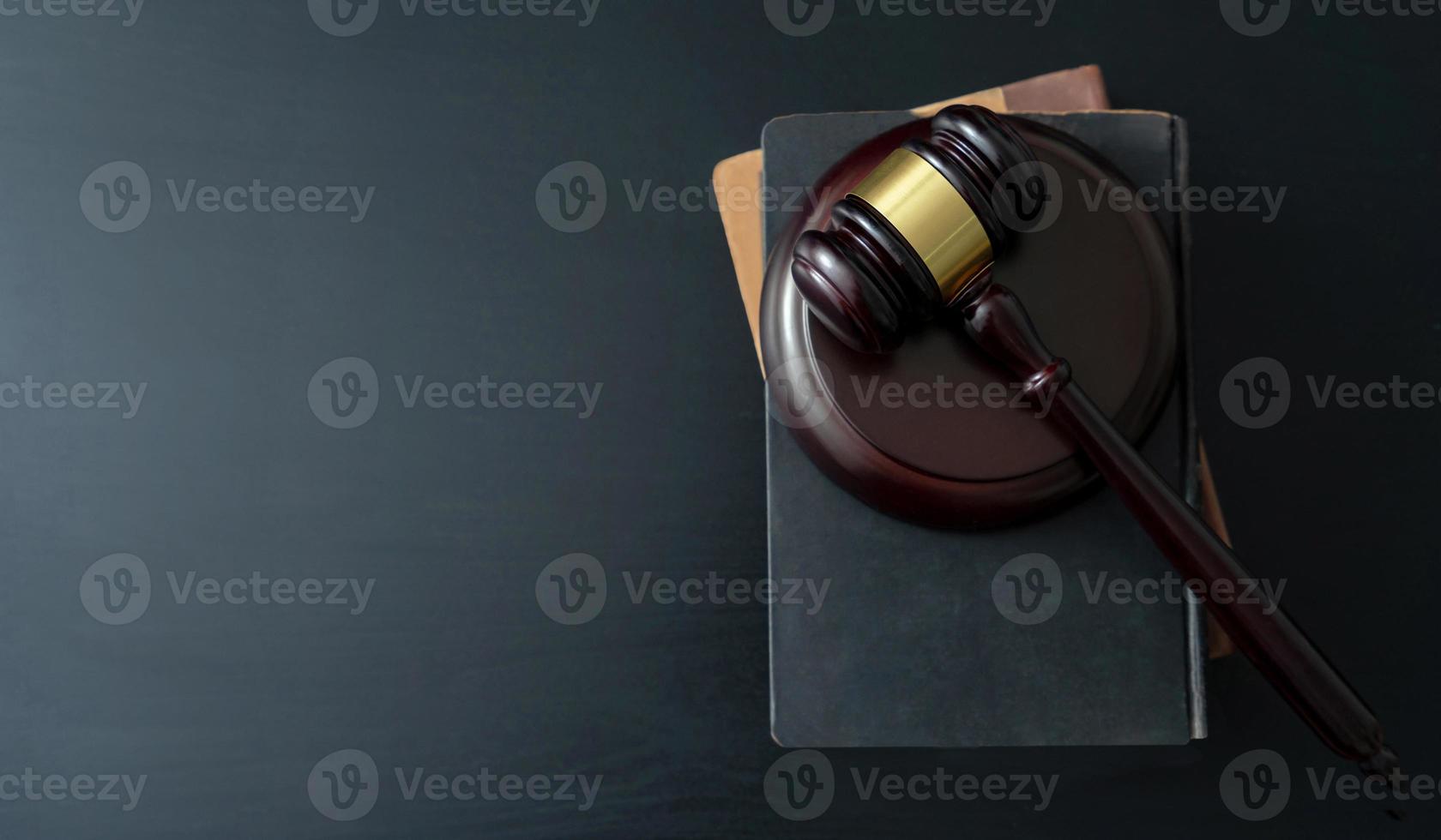 Judge gavel with books on wooden table photo