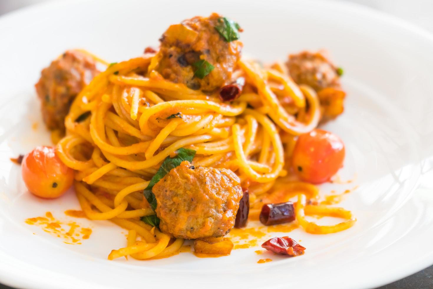 Spaghetti meatballs in white dish photo