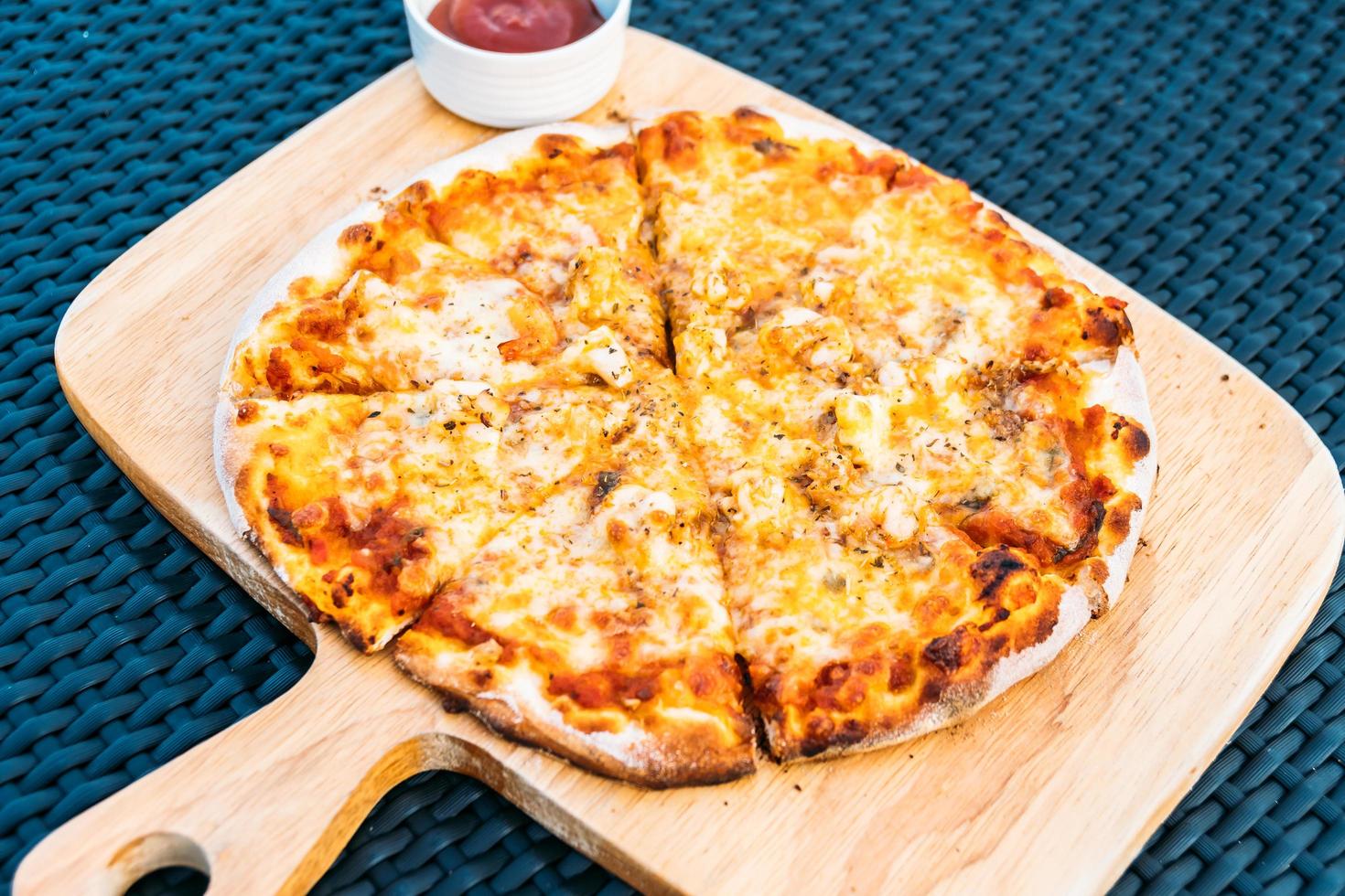 Seafood pizza on wood tray photo