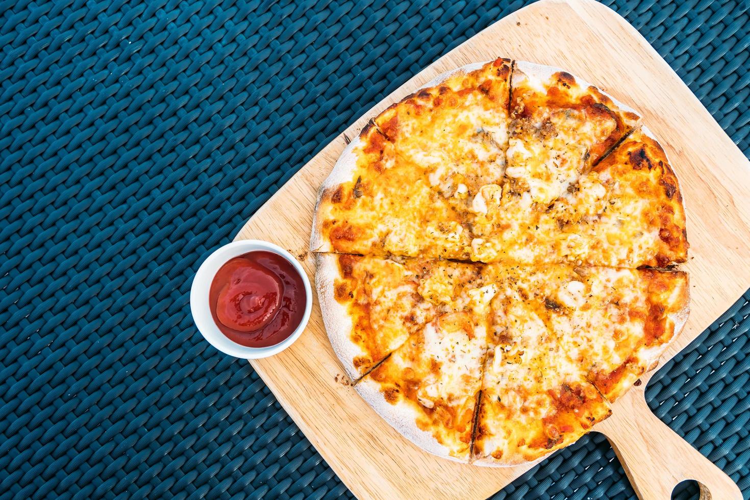 Seafood pizza on wood tray photo