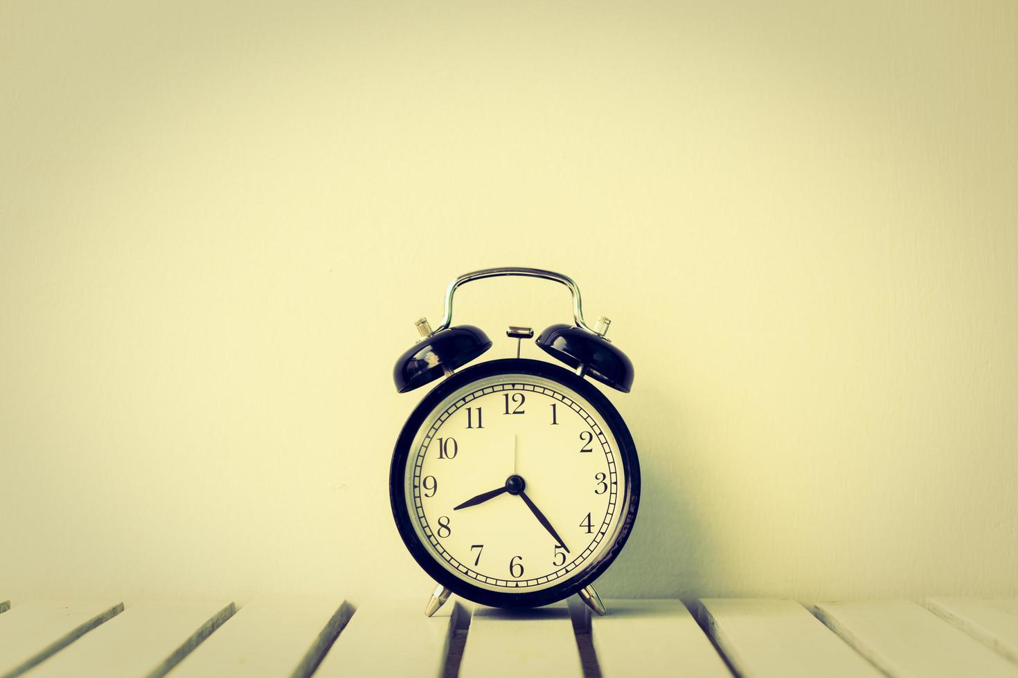 Black clock on table with copy space photo