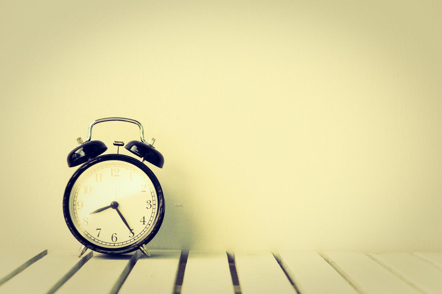 Black clock on table with copy space photo