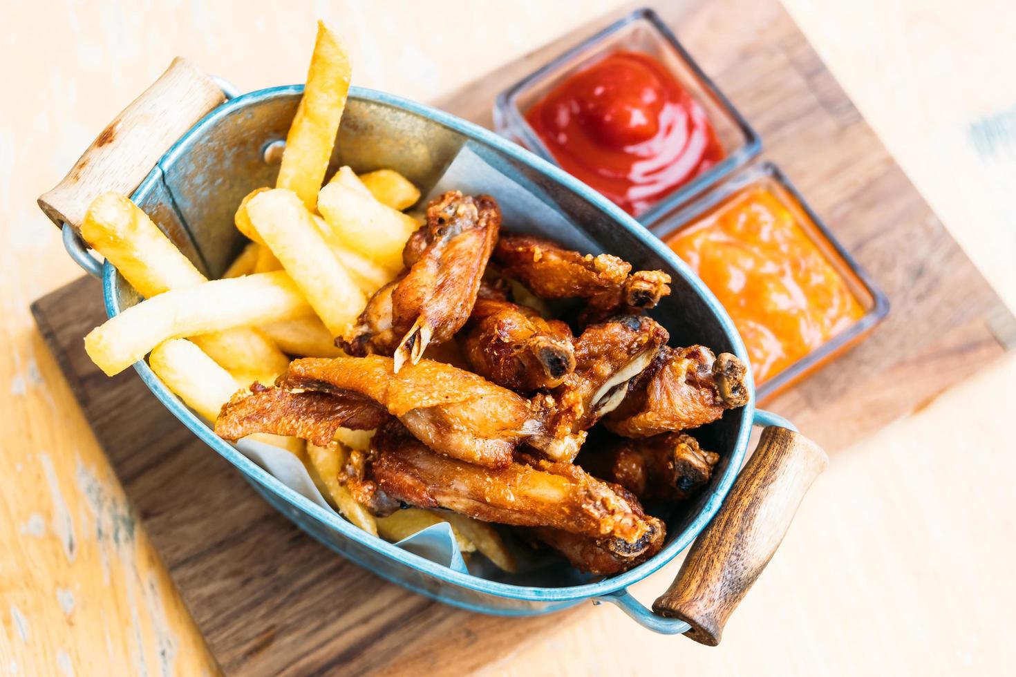 Fried chicken wing with french fries photo