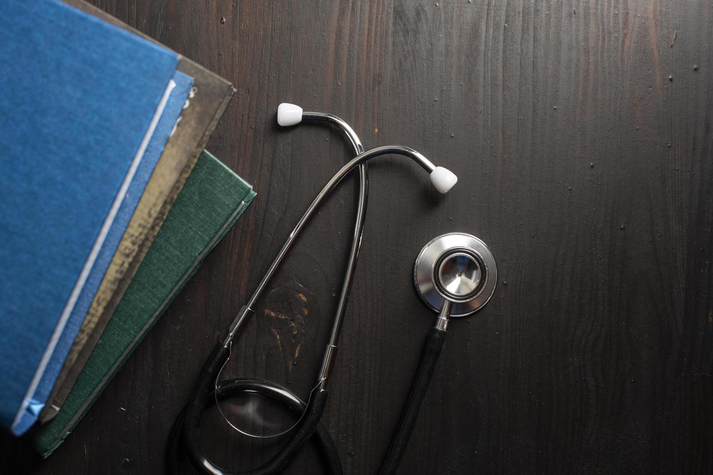 Stethoscope on desk with books photo