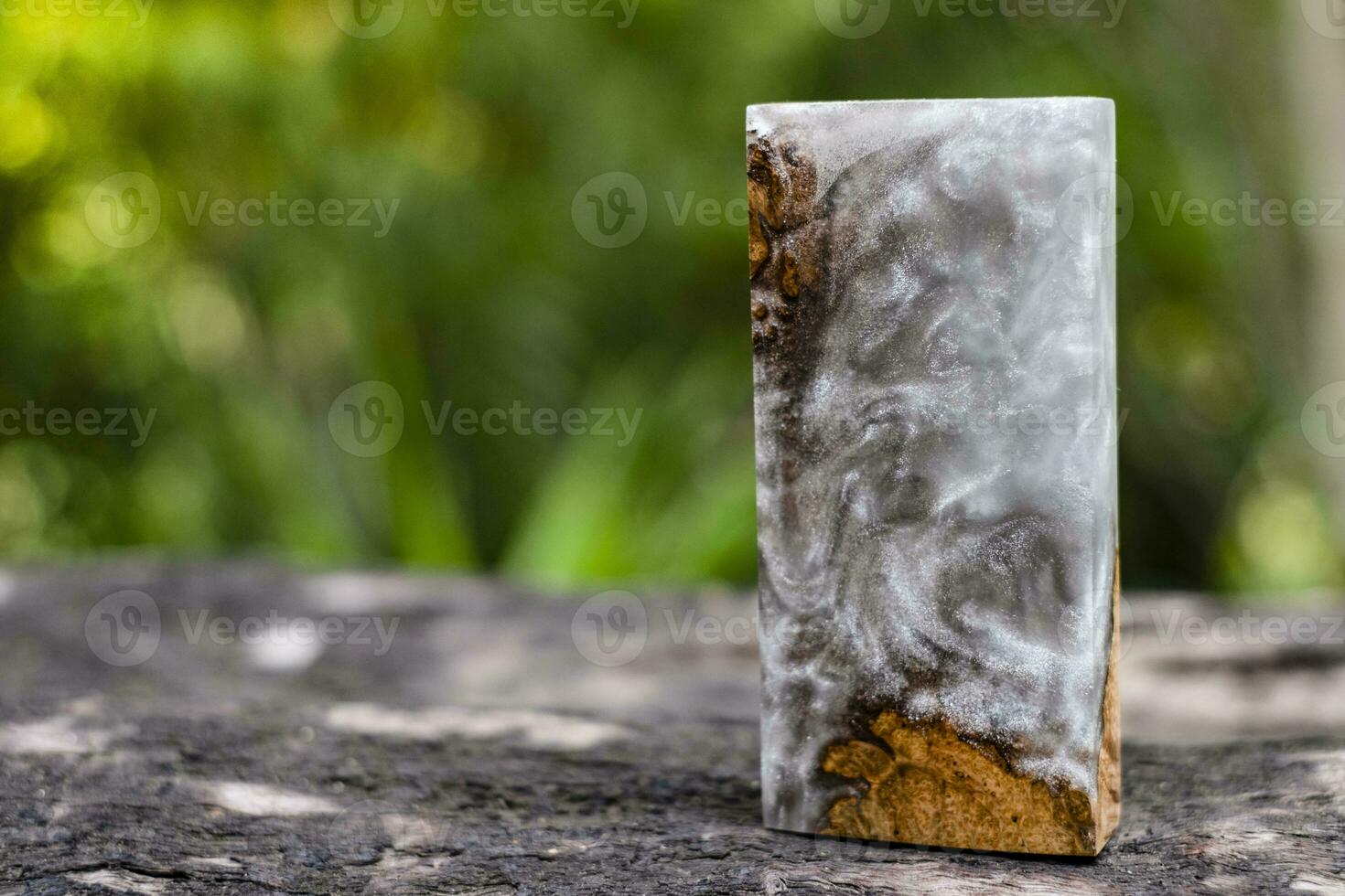 Casting epoxy resin maple burl wood on the table photo