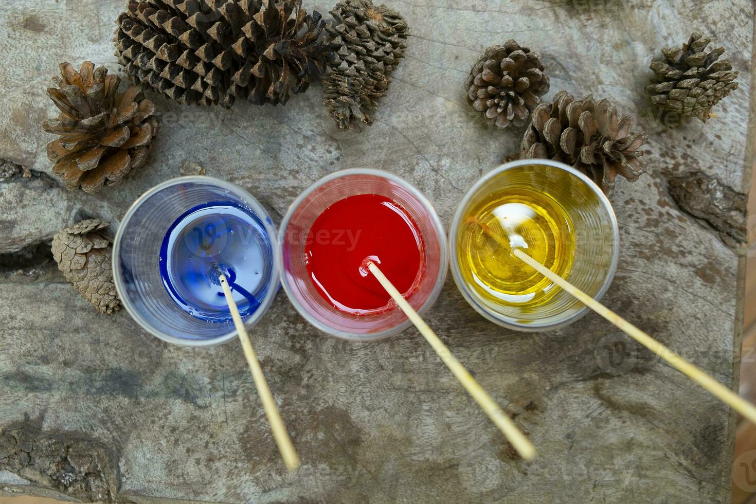 Epoxy resin Red yellow blue collor in cup for casting Stabilizing wood hybrid, abstract art background photo