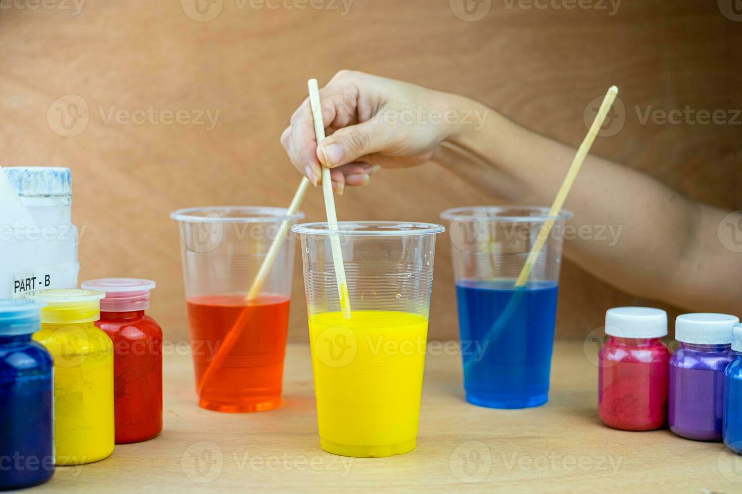 Mixing color epoxy resin in plastic cup photo