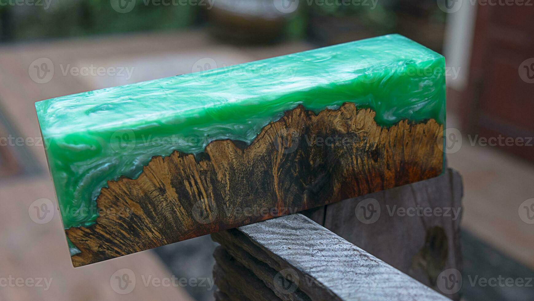 Casting epoxy resin maple burl wood on the table photo