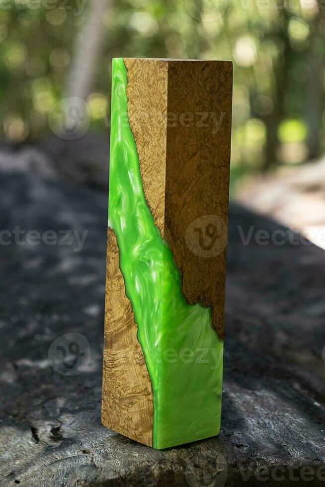 Casting epoxy resin maple burl wood on the table photo