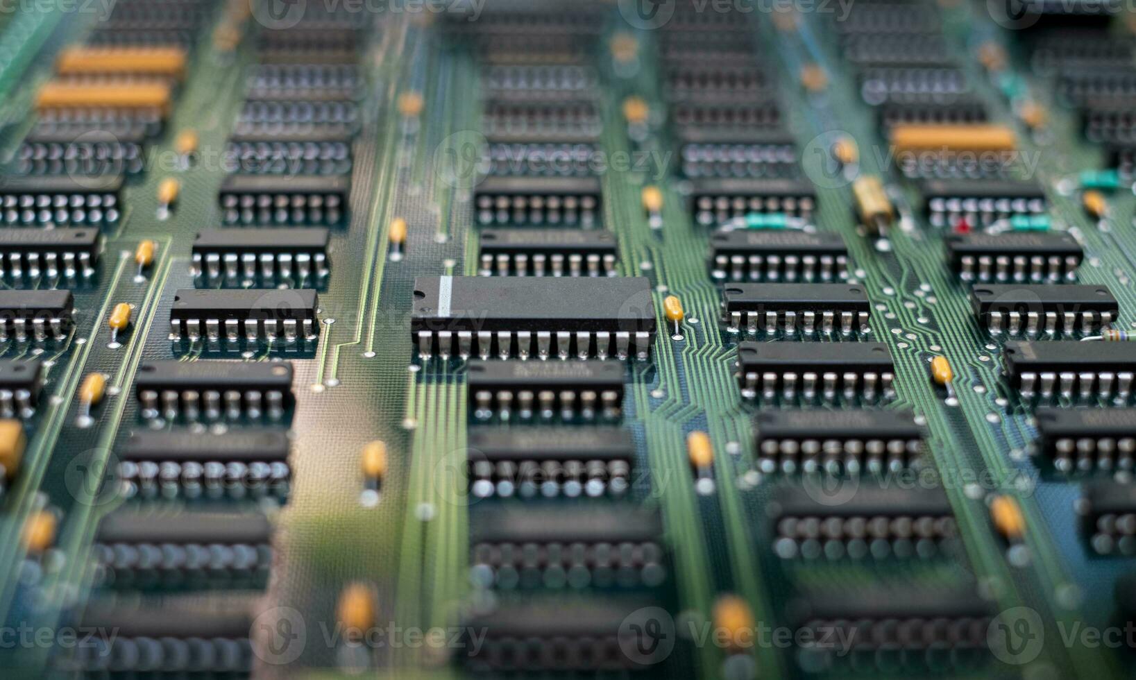 Closeup of electronic circuit board PCB components detail and in integrated circuit photo