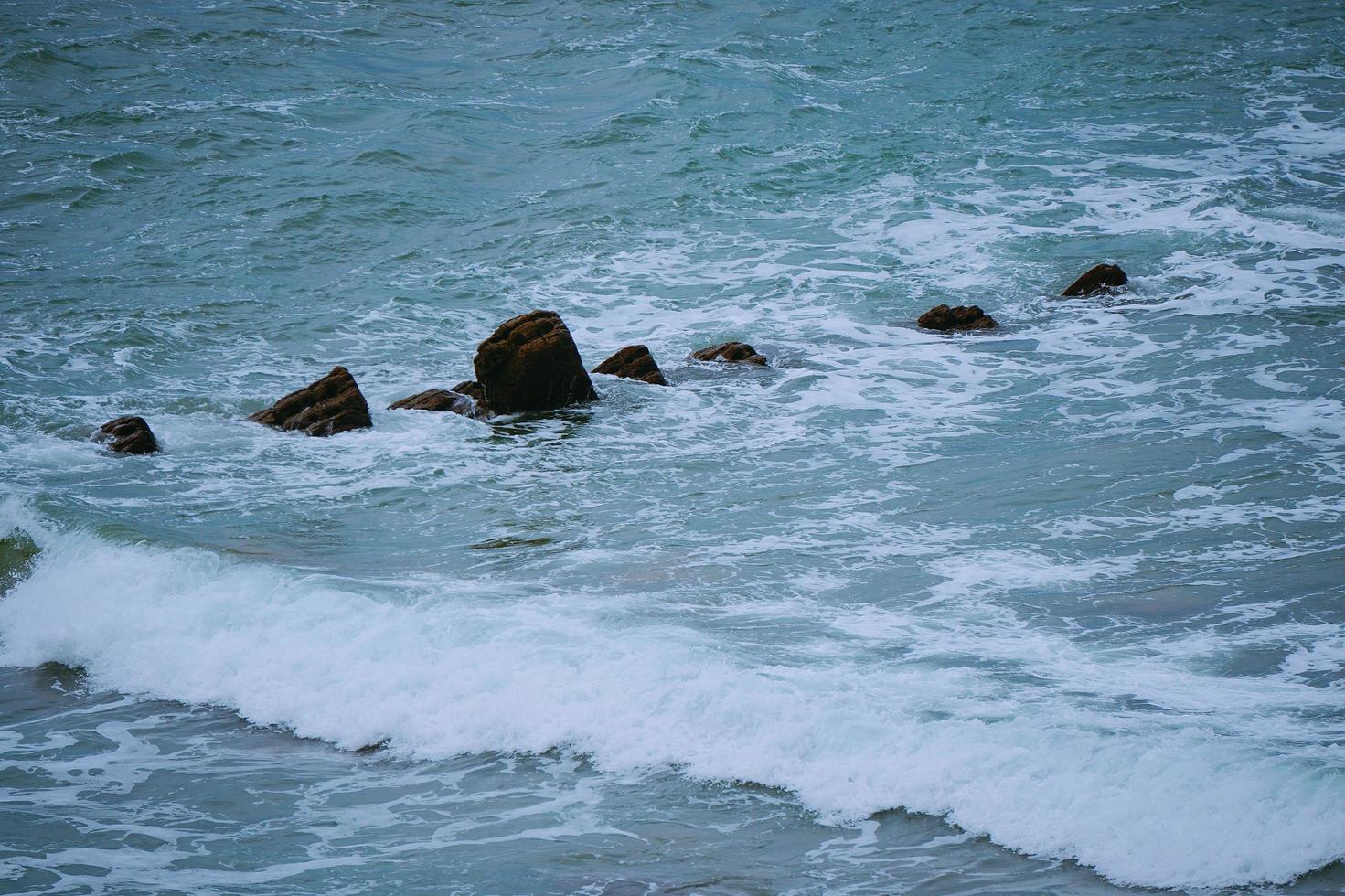 Rocks in the sea in the coast photo