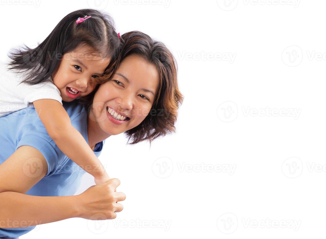 Happy mother and daughter piggybacking together isolated on white background photo