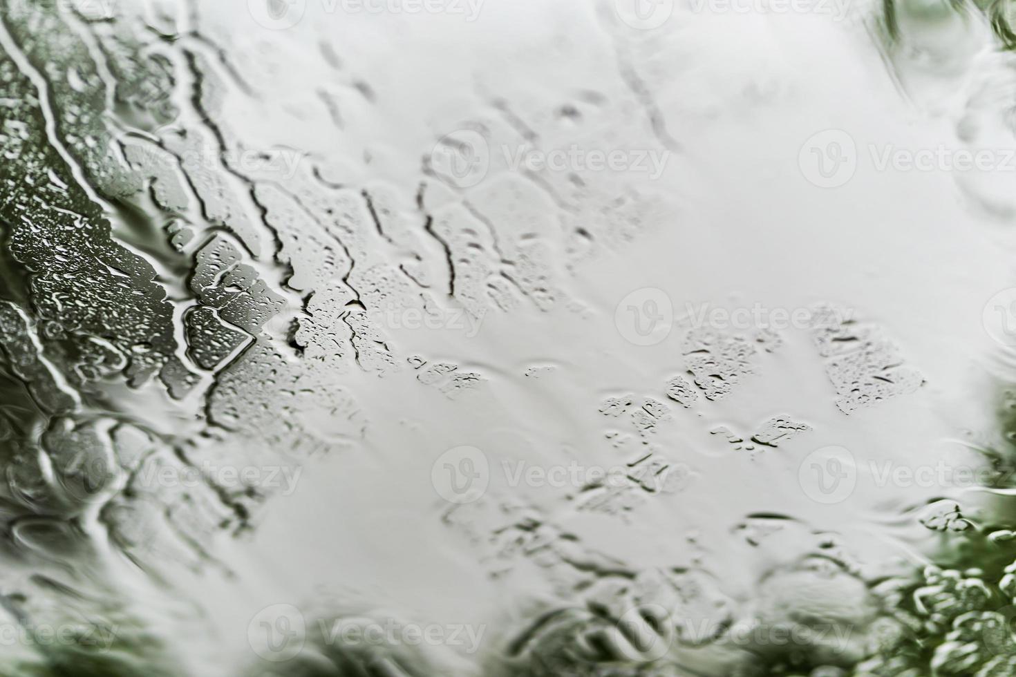 Heavy rain background, Raindrops on window glass outdoors photo