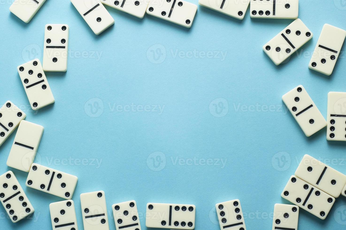 Domino pieces on blue background with an empty space for text photo