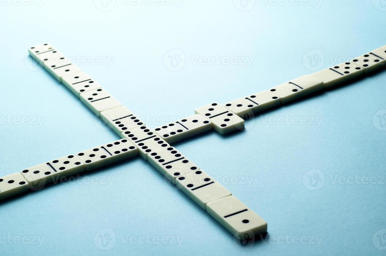 Domino pieces on blue background with an empty space for text photo