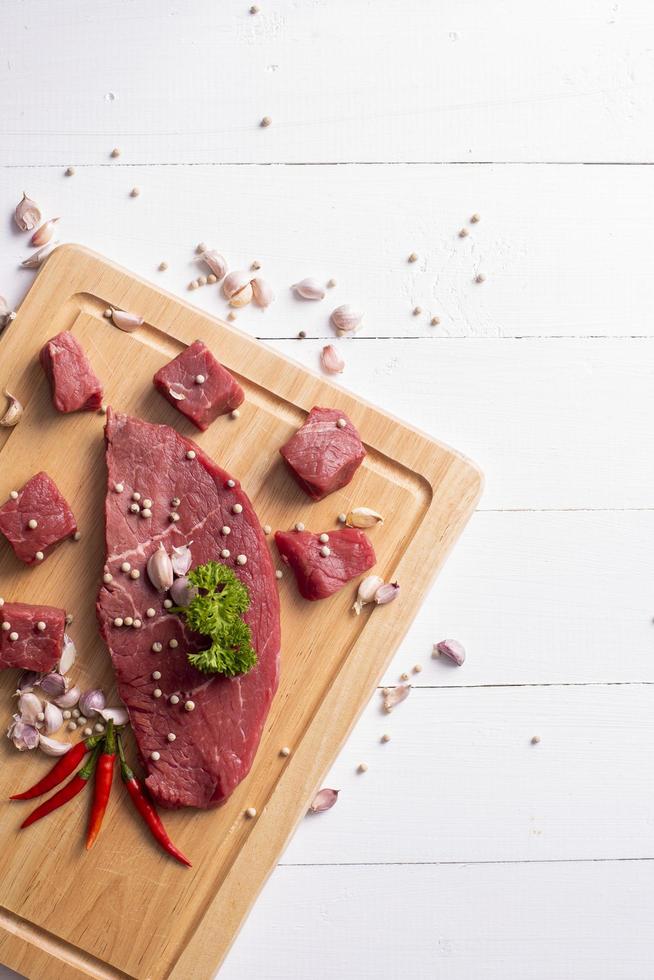 Raw beef on white wood background photo