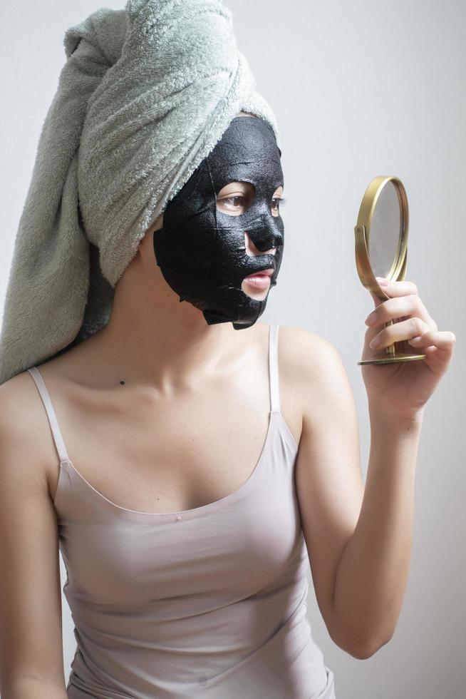 Beautiful woman with Black  facial mask, Lifestyle concept photo