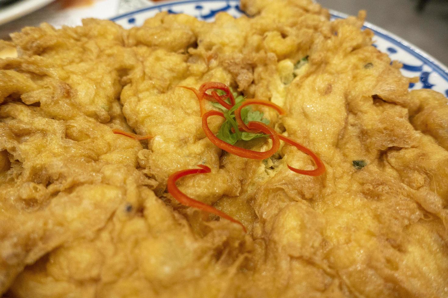 Thai omelette on dish photo