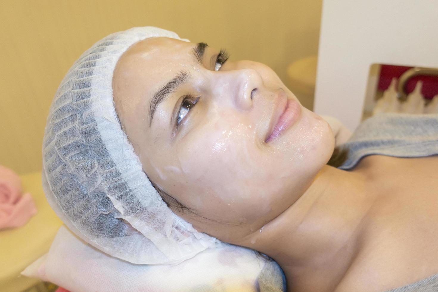 Beautiful woman is doing skincare treatment her face in beauty clinic photo