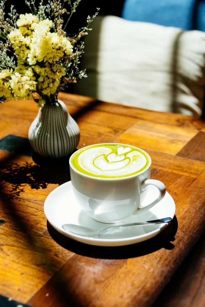 Green tea matcha latte in white cup photo