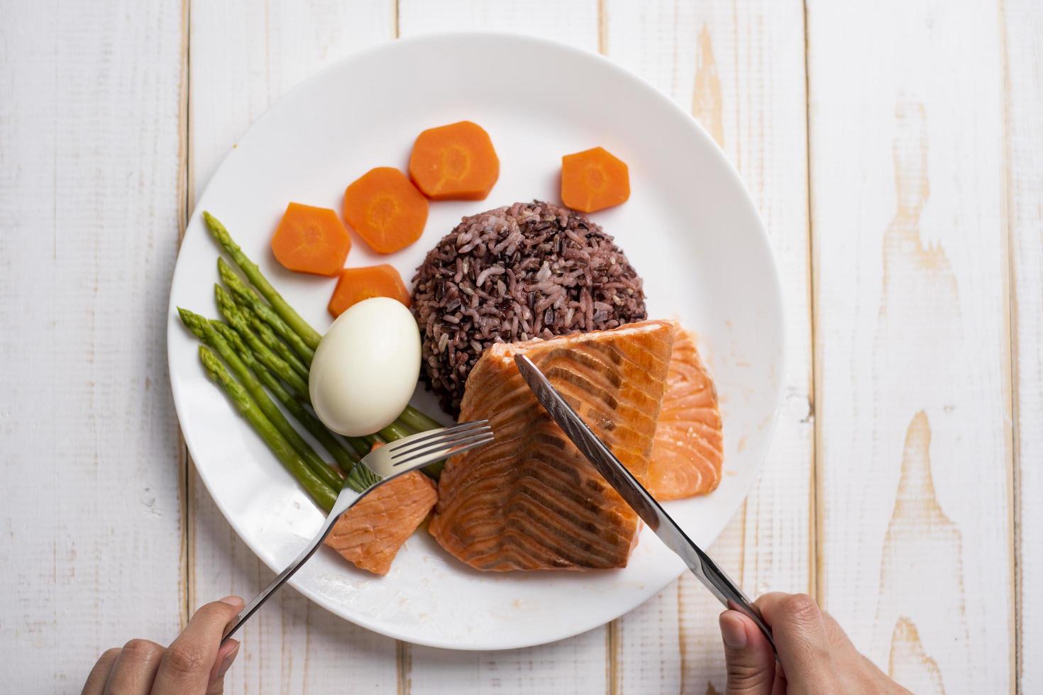 Health food concept, salmon with rice and vegetable on wood background photo