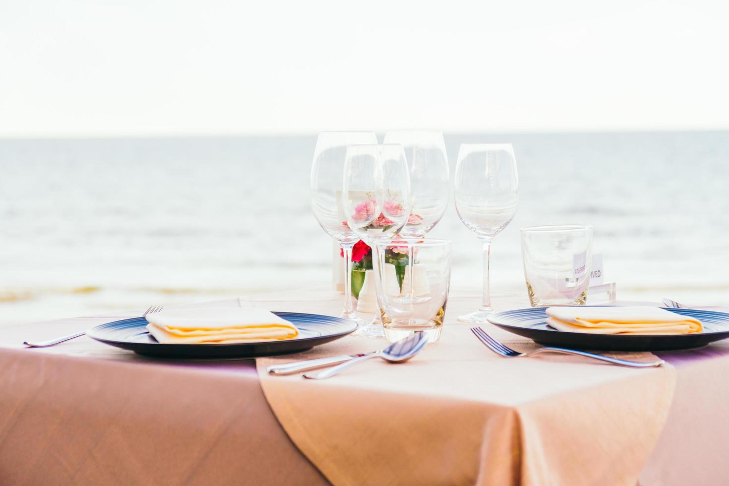 Romantic dining table setting with wine glass and other photo