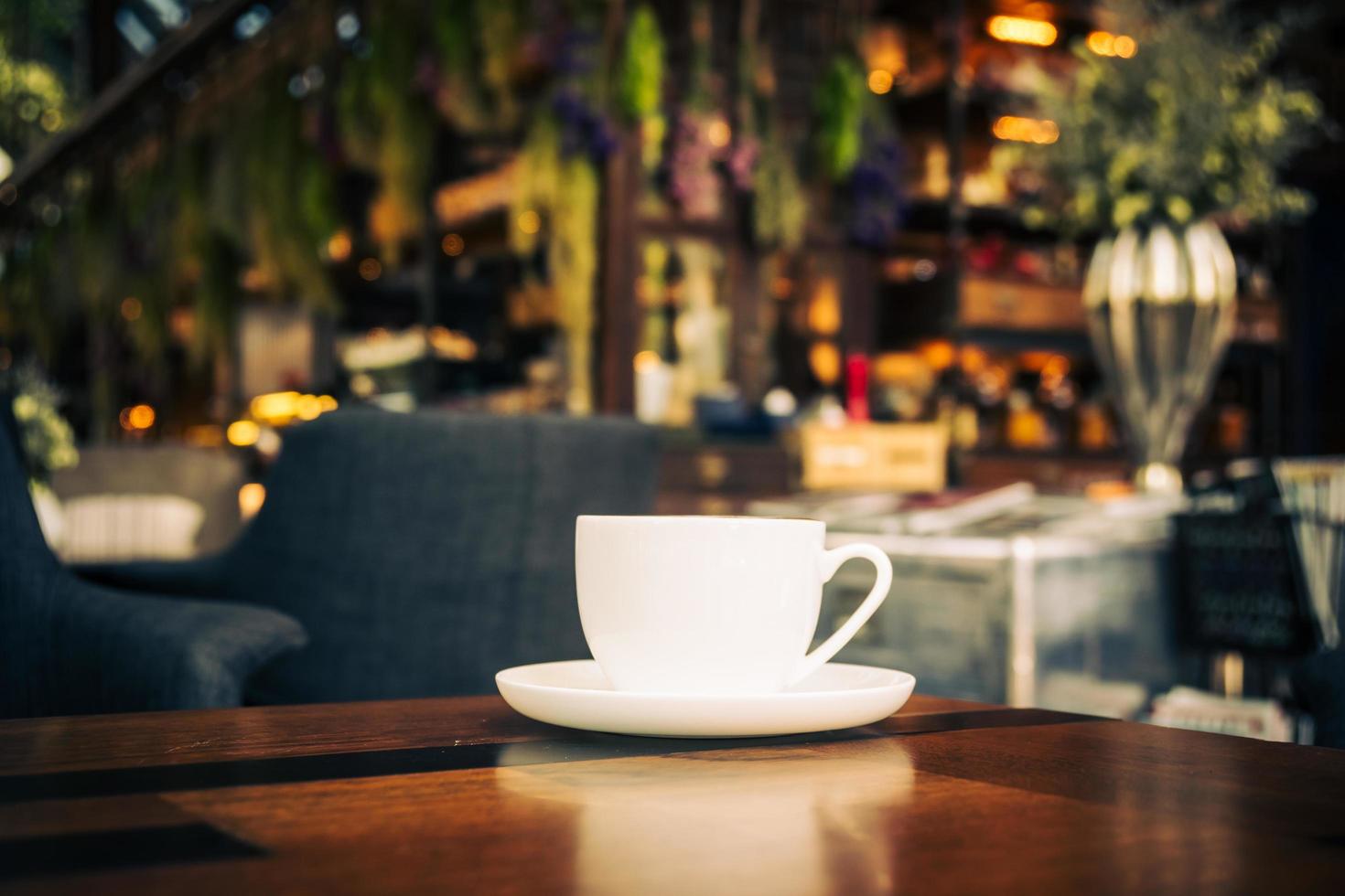 Hot latte coffee in white cup on table in restaurant and cafe photo