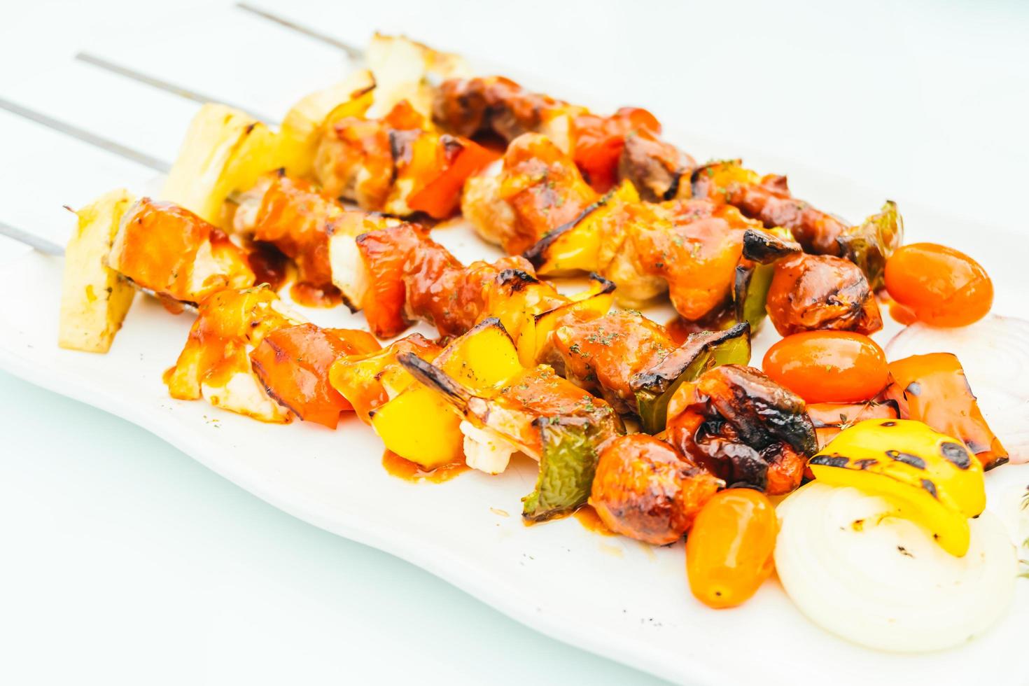 Grilled bbq meat stick in white plate photo
