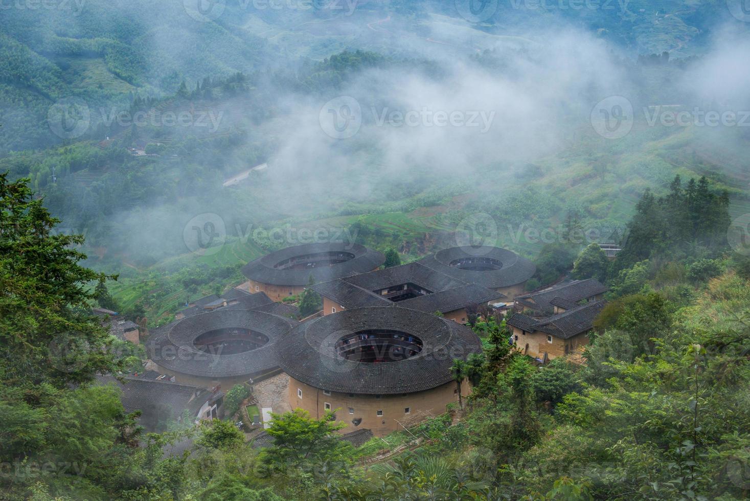 Aerial view of Tianluokeng Tulou cluster with mist, China photo