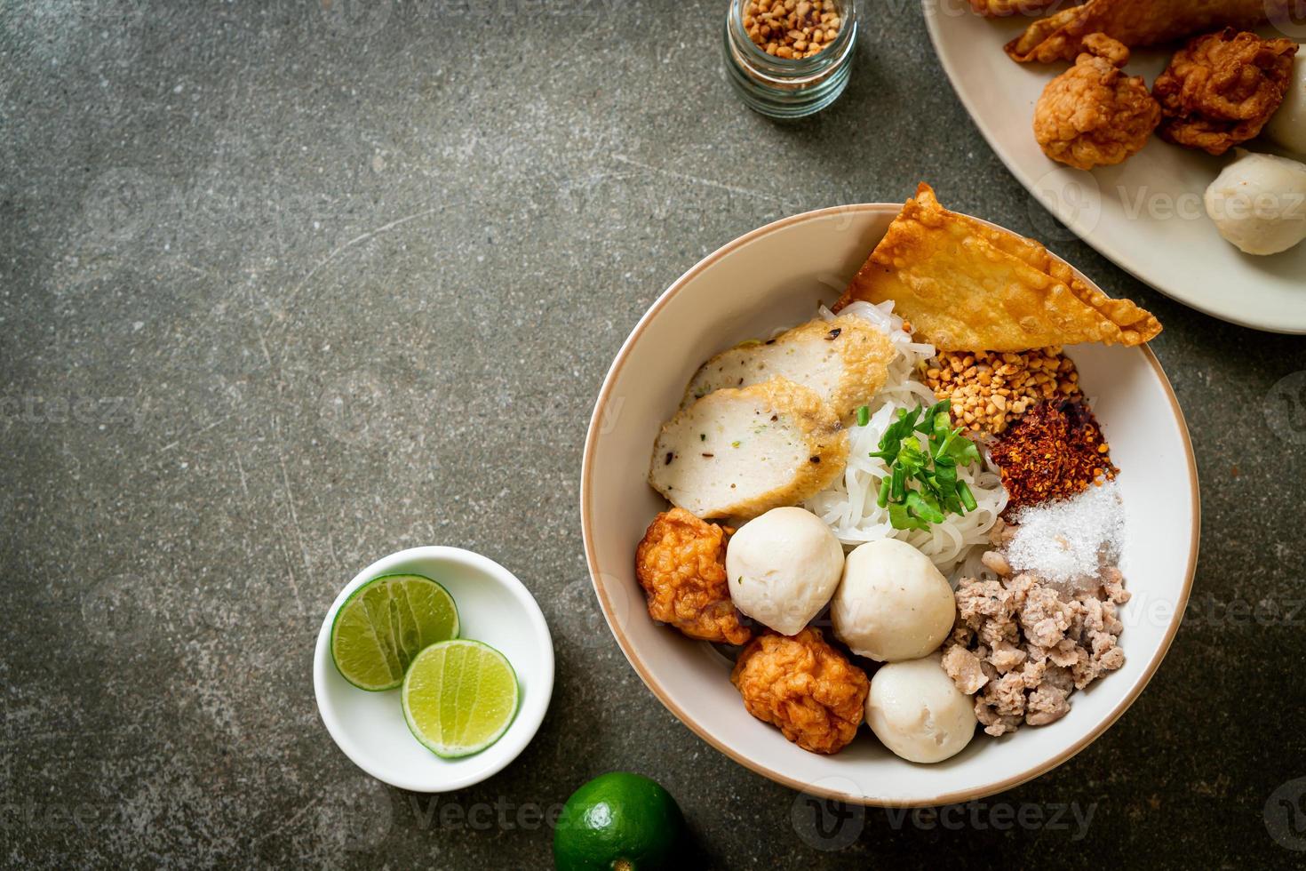 Spicy small flat rice noodles with fish balls and shrimp balls without soup - Asian food style photo