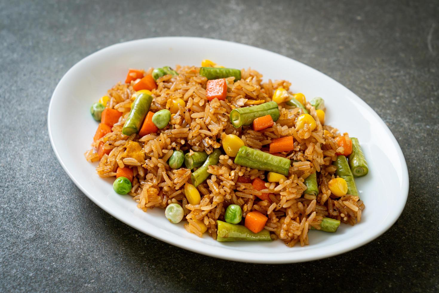 Fried rice with green peas, carrot and corn - vegetarian and healthy food style photo