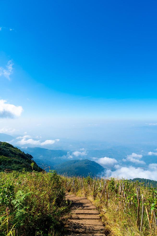 Beautiful mountain layer with clouds and blue sky at Kew Mae Pan Nature Trail in Chiang Mai, Thailand photo