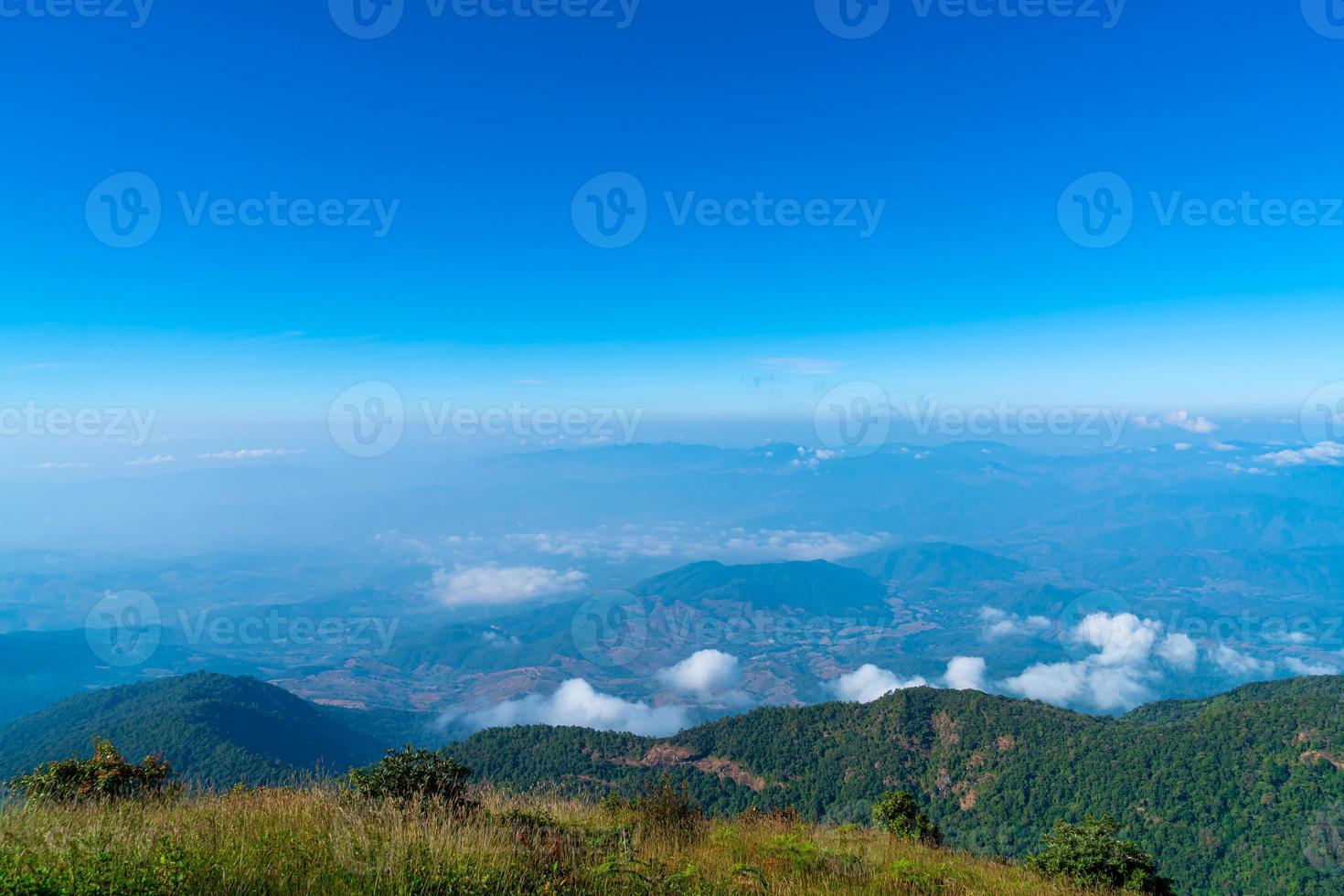 Beautiful mountain layer with clouds and blue sky at Kew Mae Pan Nature Trail in Chiang Mai, Thailand photo