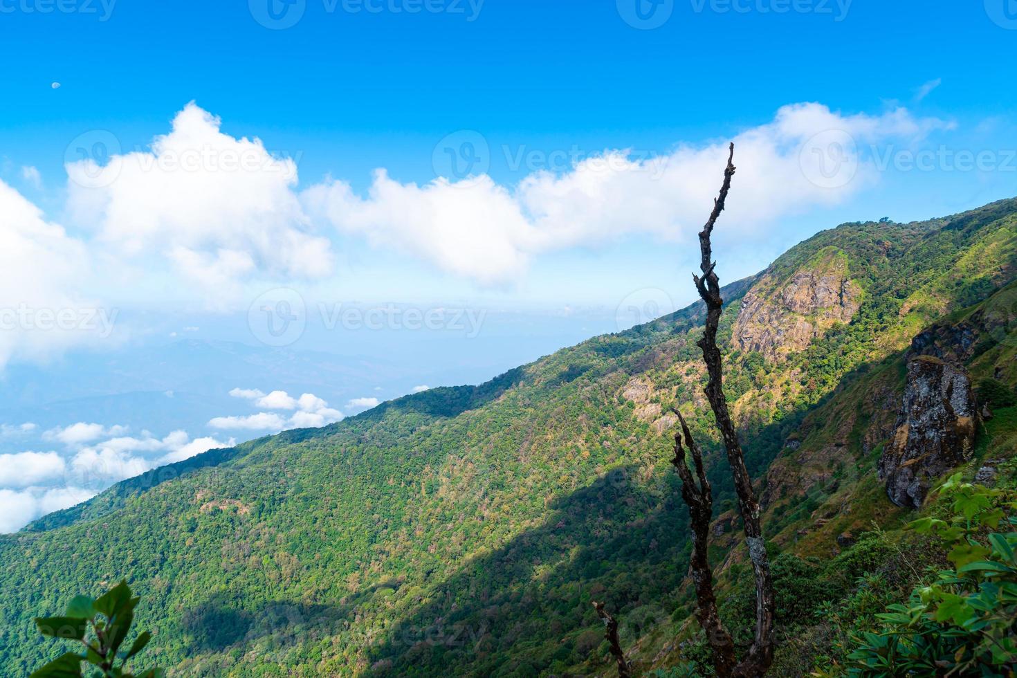 Beautiful mountain layer with clouds and blue sky at Kew Mae Pan Nature Trail in Chiang Mai, Thailand photo