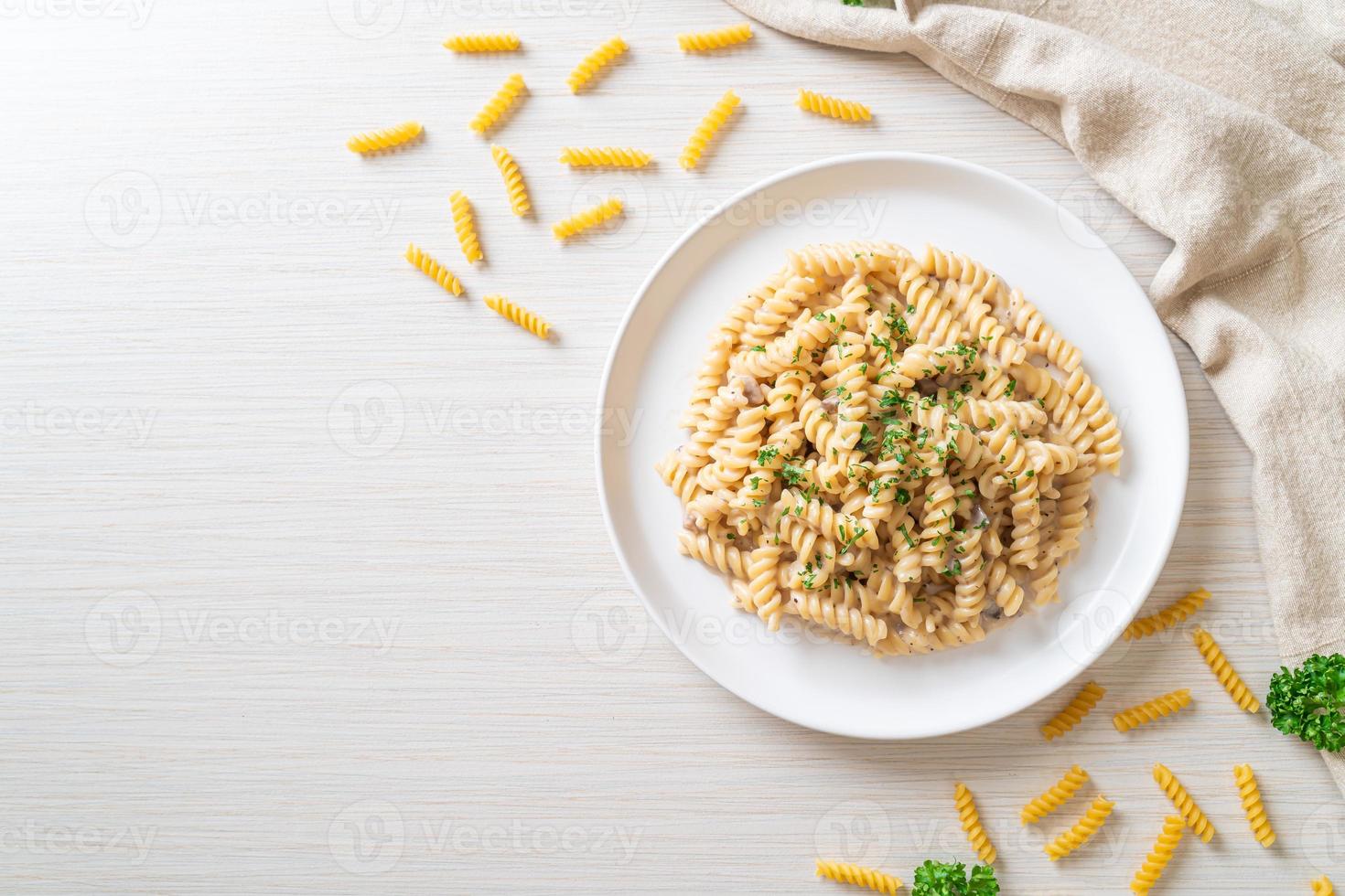 Spirali or spiral pasta mushroom cream sauce with parsley - Italian food style photo